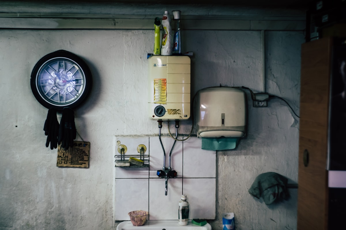 Wall-mounted hot water unit above a utility sink