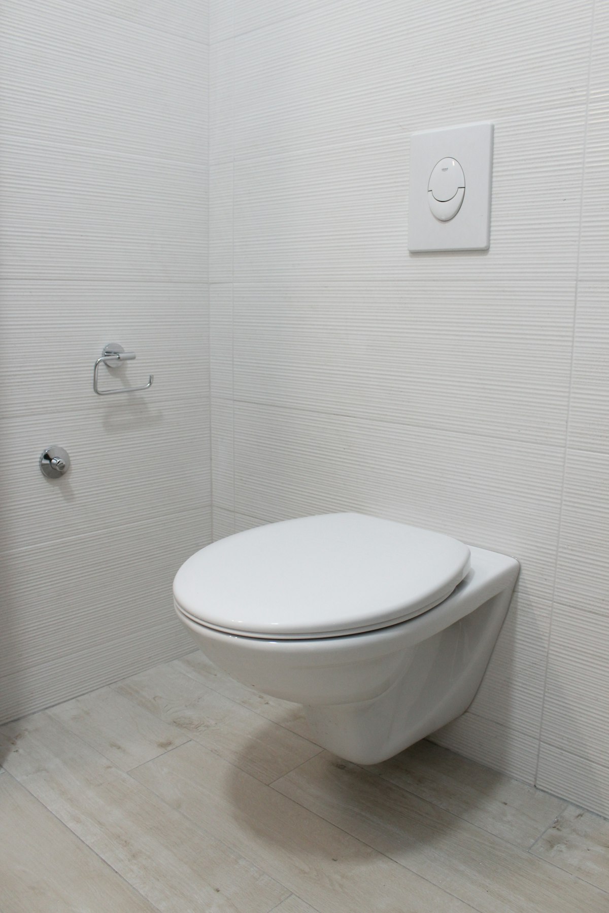 Modern white wall-hung toilet with dual-flush cistern plate